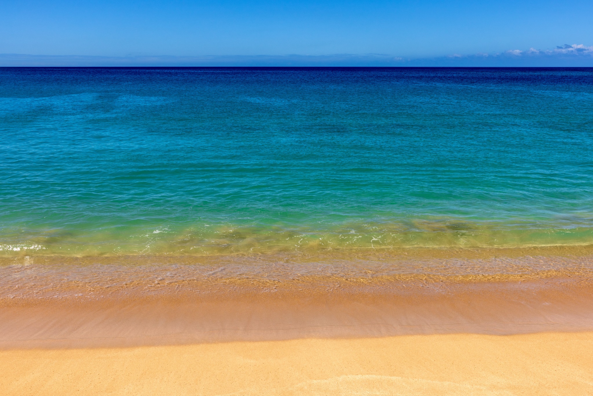 A Hawaiian beach in many layers of blue and tan.